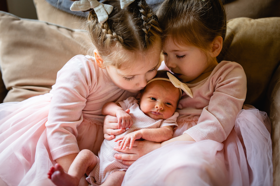 sisters and newborn